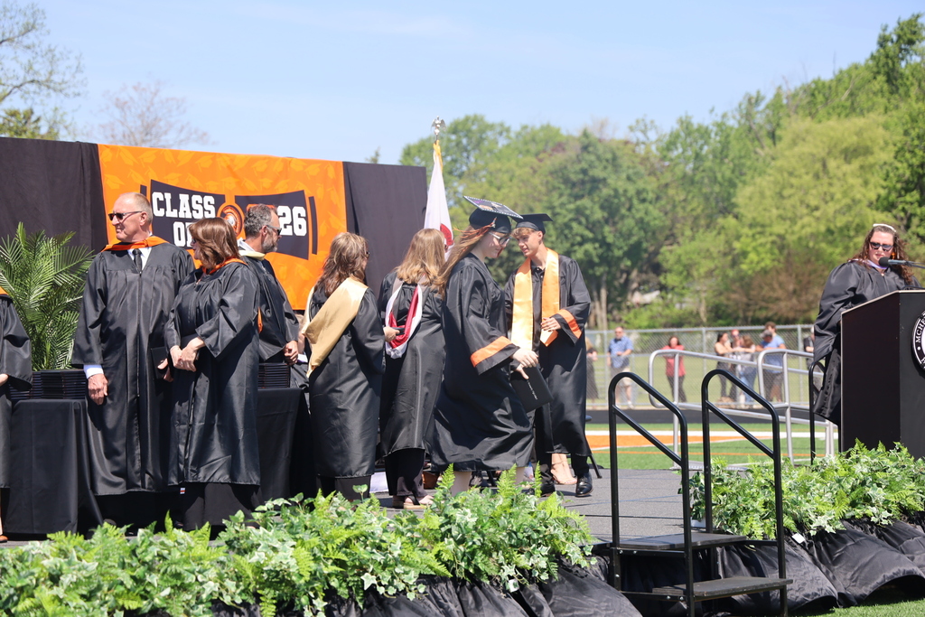 Students walking on the stage at graduation