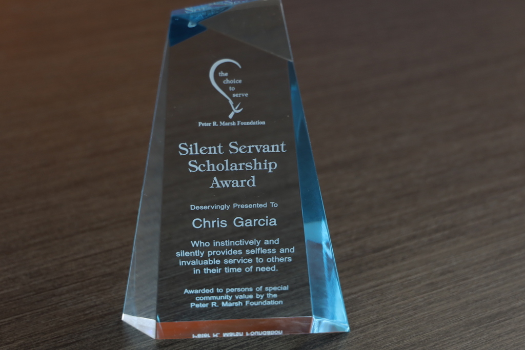 Glass award for the choice to serve Peter R. Marsh Foundation Silent Servant Scholarship Award Deservingly Presentd to Chris Garcia Who instinctively and silently provides  selfless and invaluable service to others in their time of need. Awarded to persons of special community value by the Peter R. Marsh Foundation