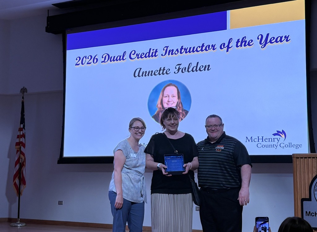 Annette Folden holding award with MCC Staff member and Carl Vallinanots in front of slide that says 2026 Dual Credit Instructor of the Year McHenry County College