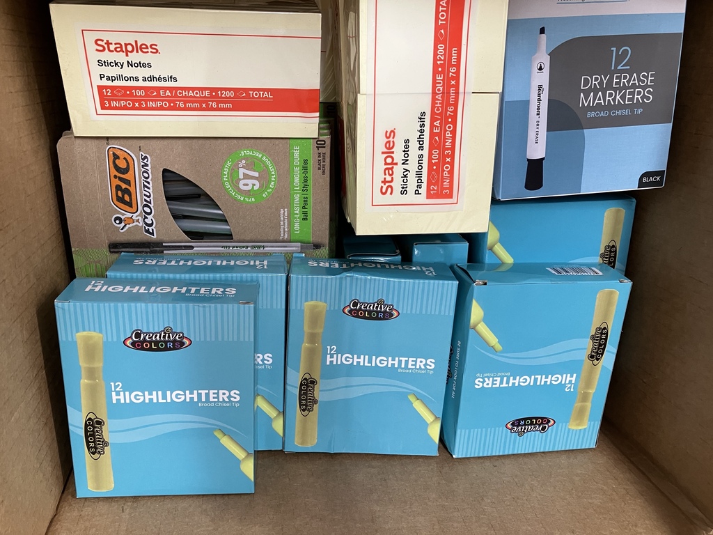 Box of highlighters, pens, sticky notes and dry erase markers