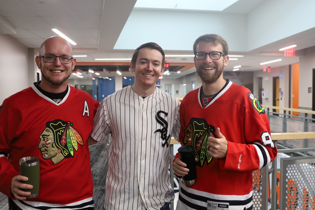 Three staff members in jerseys 