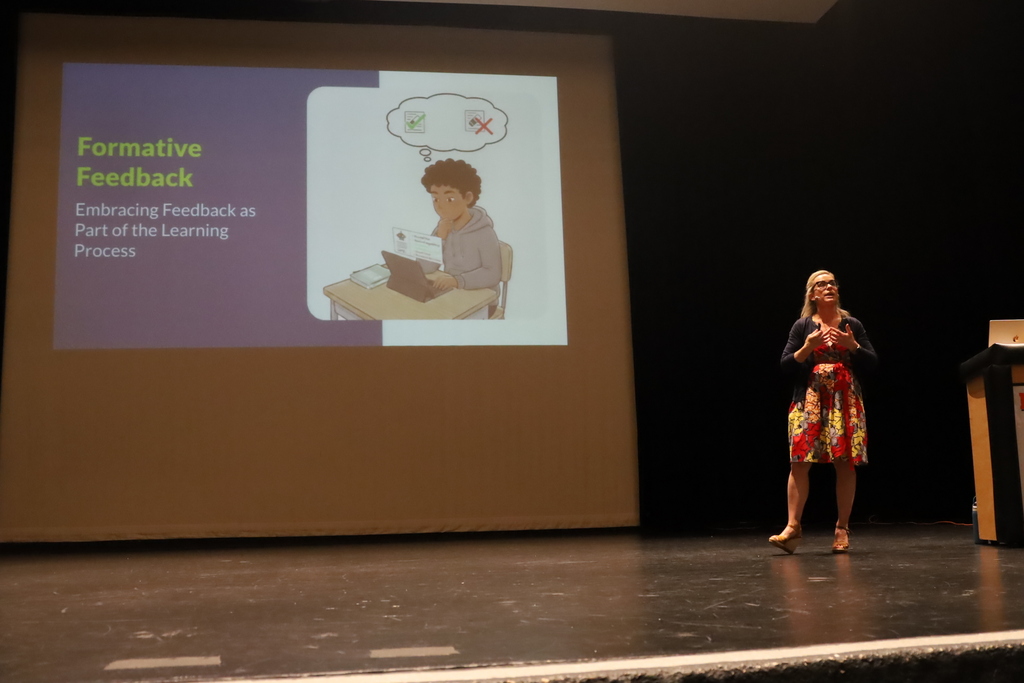 Catlin Tucker on stage in front of slide that says Formative Feedback embracing feedback as part of the learning process