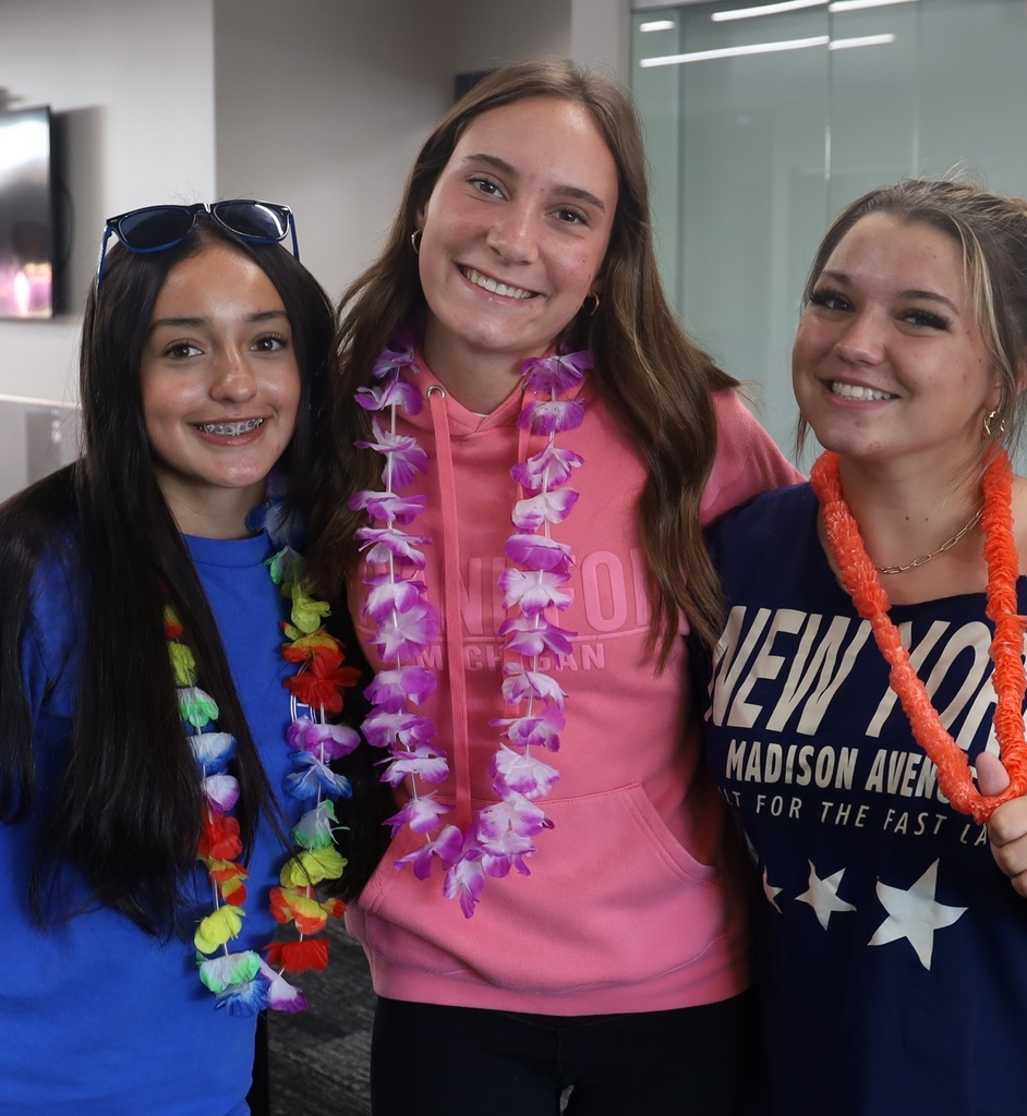 Three kids wearing leis 