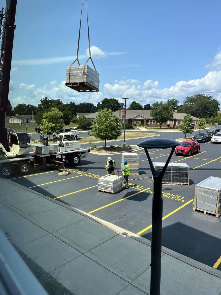 Crane in parking lot with panels