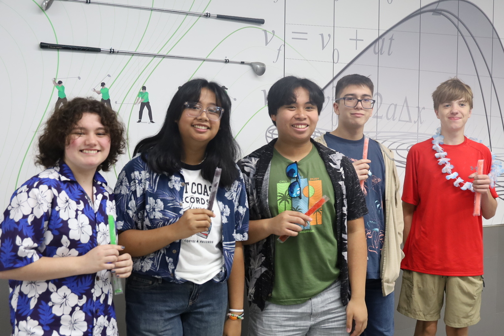 Four students in Hawaiian gear with freeze pops