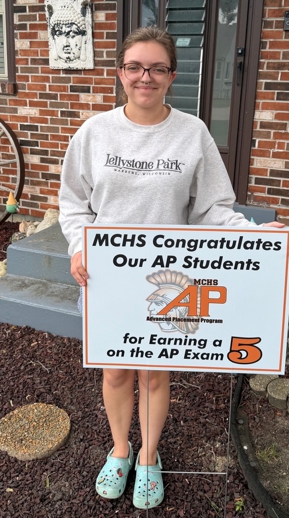 Student in yard with AP sign