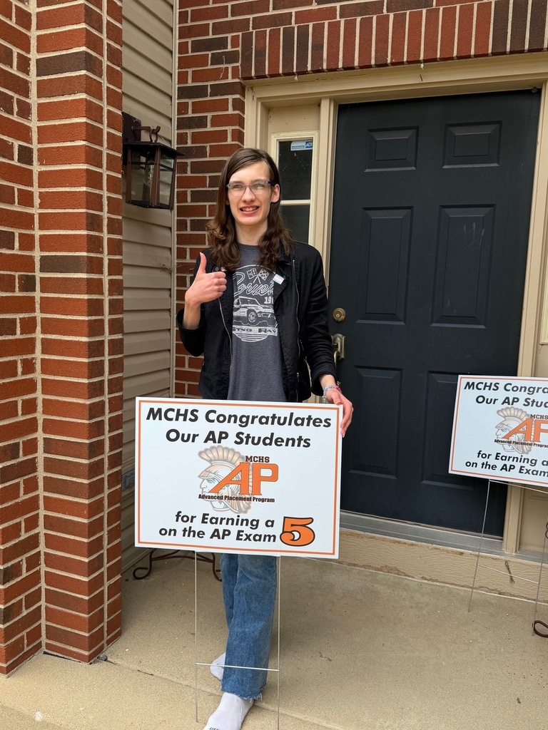Student in yard with AP sign