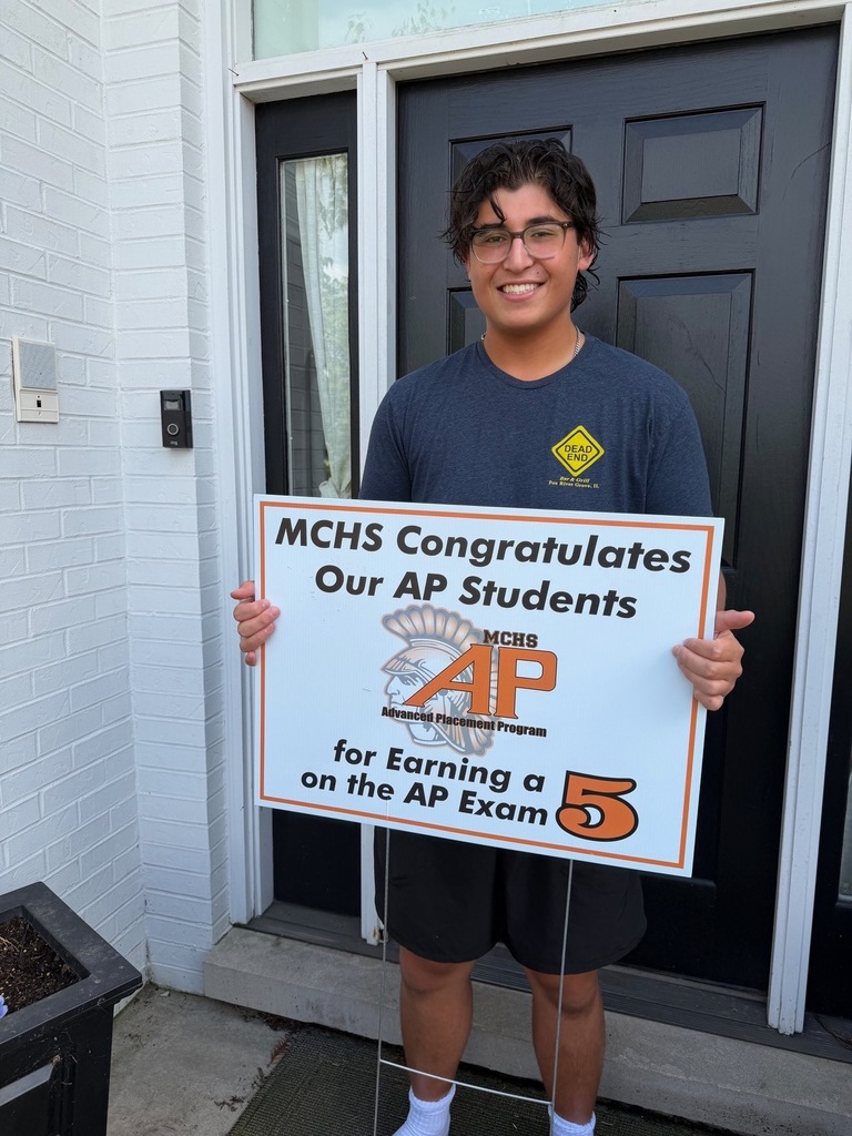 Student in yard with AP sign