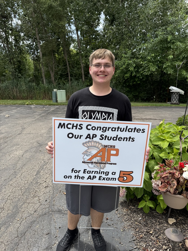 Student in yard with AP sign