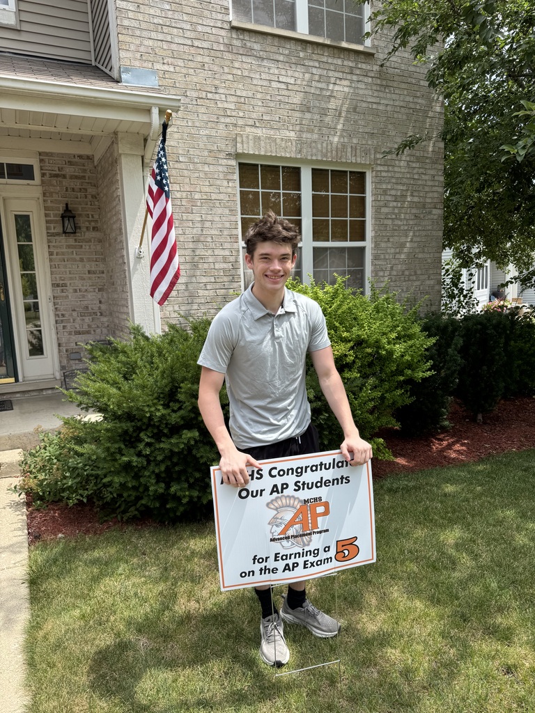 Student in yard with AP sign