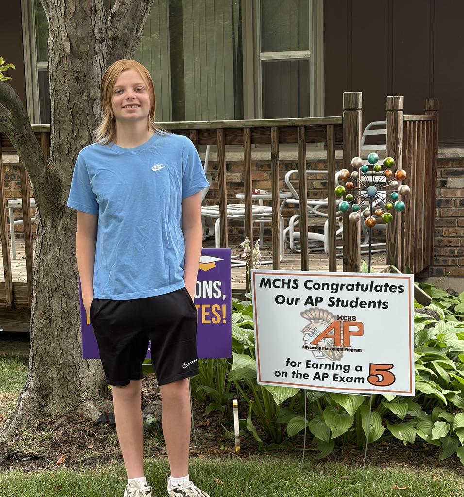 Student in yard with AP sign
