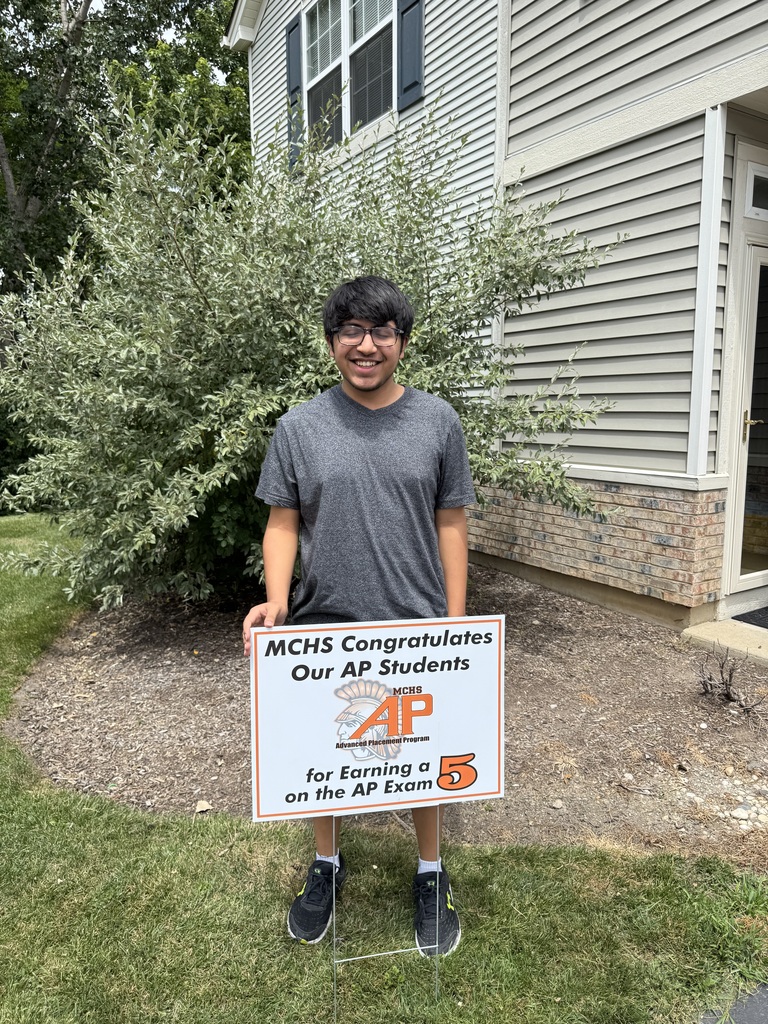 Student in yard with AP sign