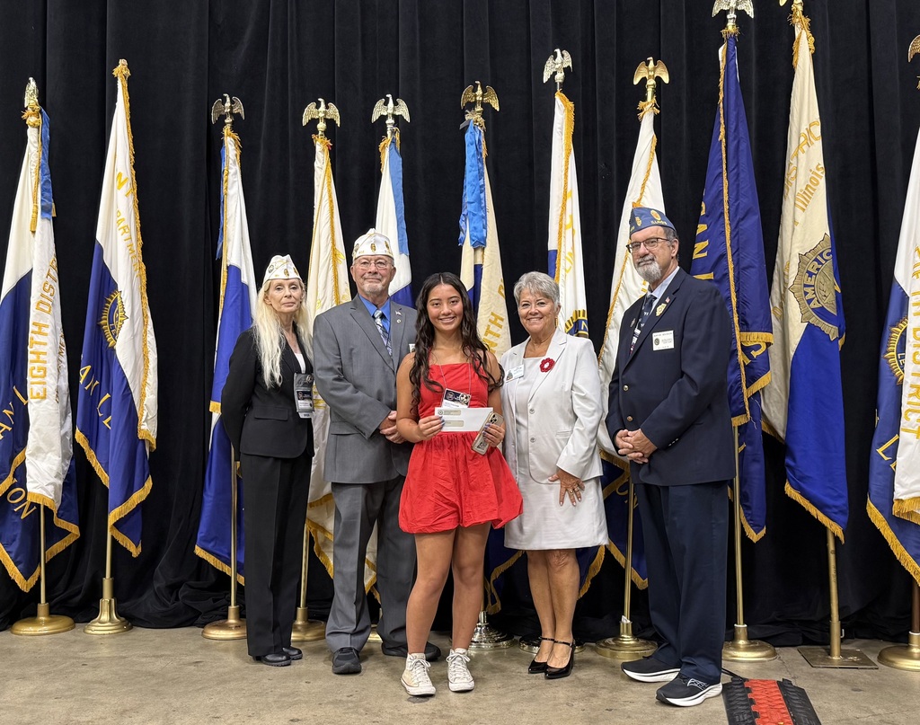 Amaya holding her award with four people from the American legion