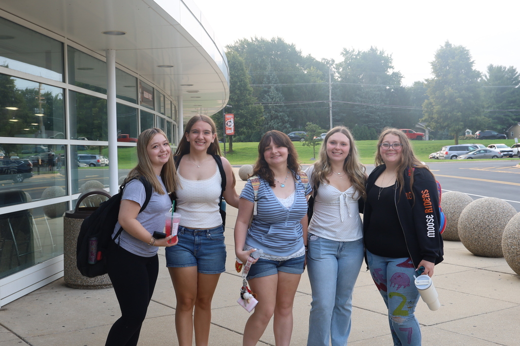 Five students posing outside