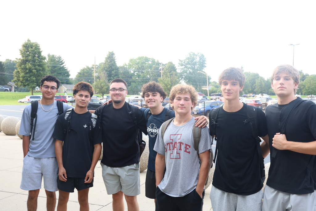 Group of seven students outside posing 