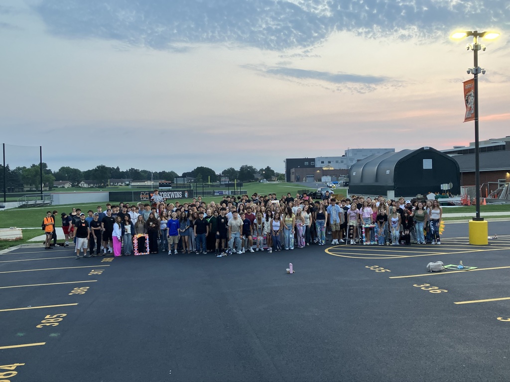 Group of students in front of sunrise in the parking lot