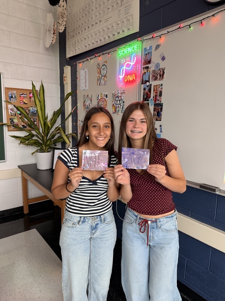 Two students holding name tags