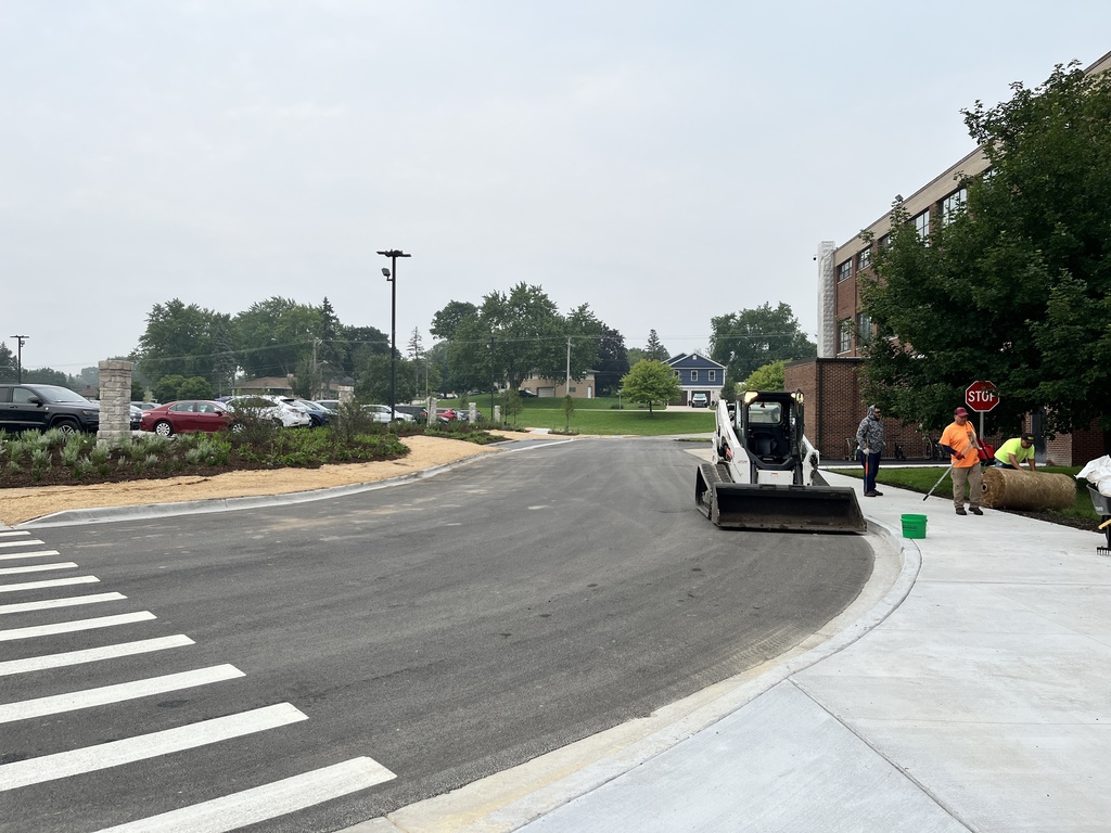 Workers installing more landscaping at the newly designed parking area behind Freshman Campus