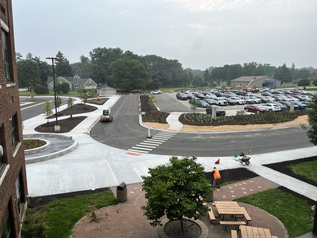 Workers installing more landscaping at the newly designed parking area behind Freshman Campus