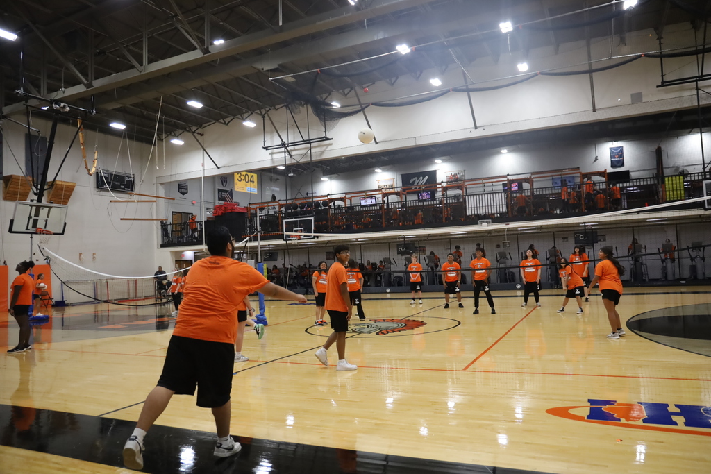 Students playing volleyball in the gym