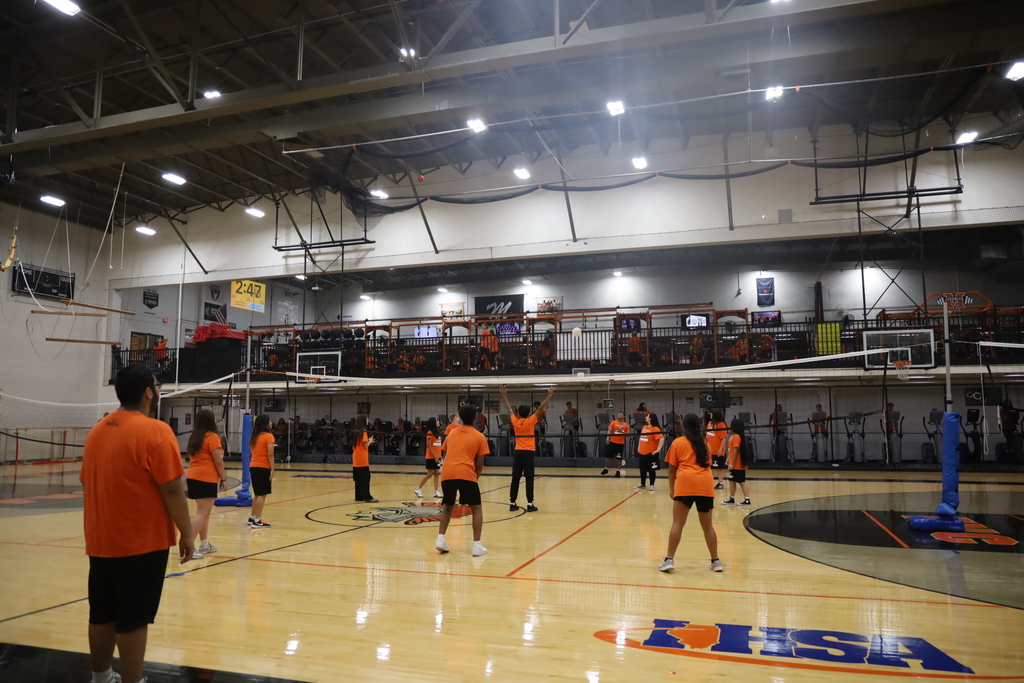Students playing volleyball in the gym