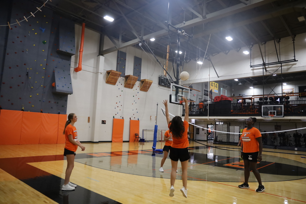 Students playing volleyball in the gym