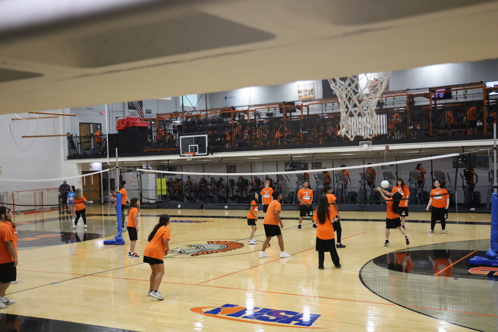 Students playing volleyball in the gym