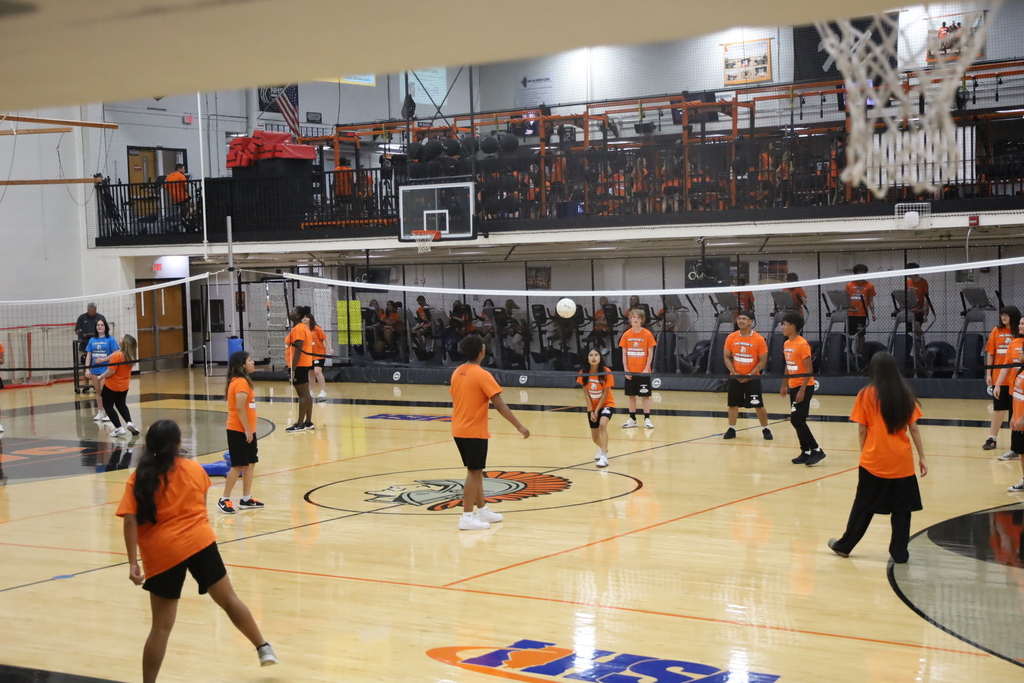 Students playing volleyball in the gym