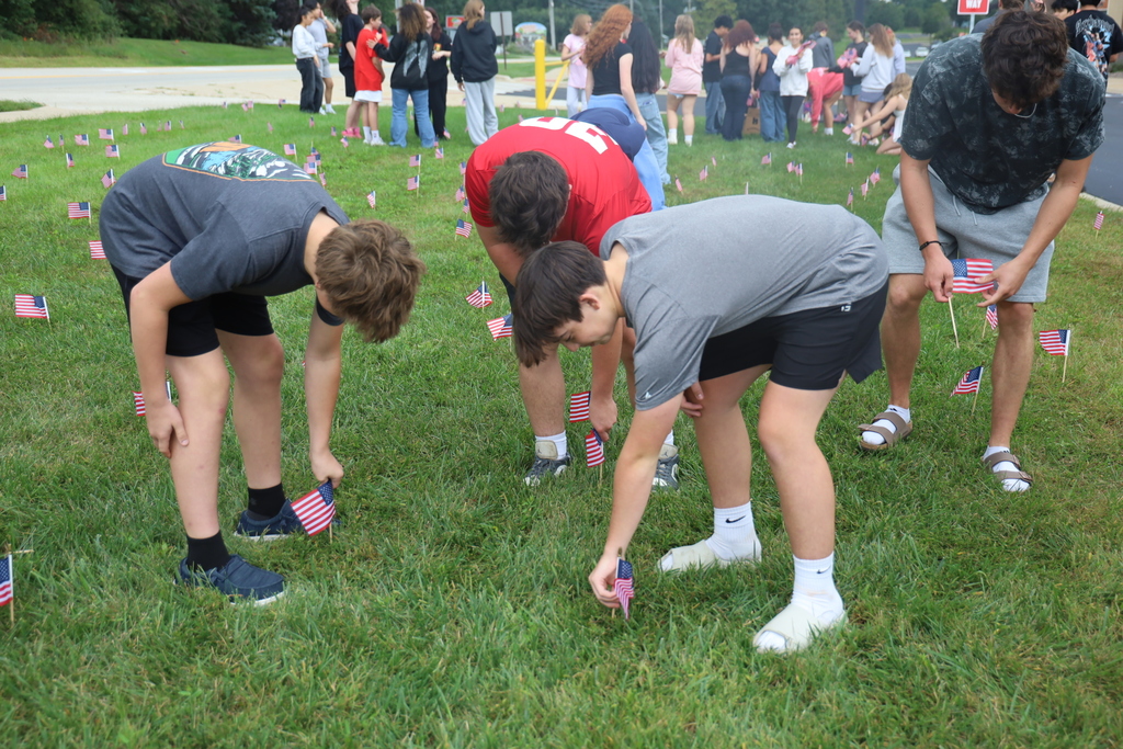 Students planting flags in the ground