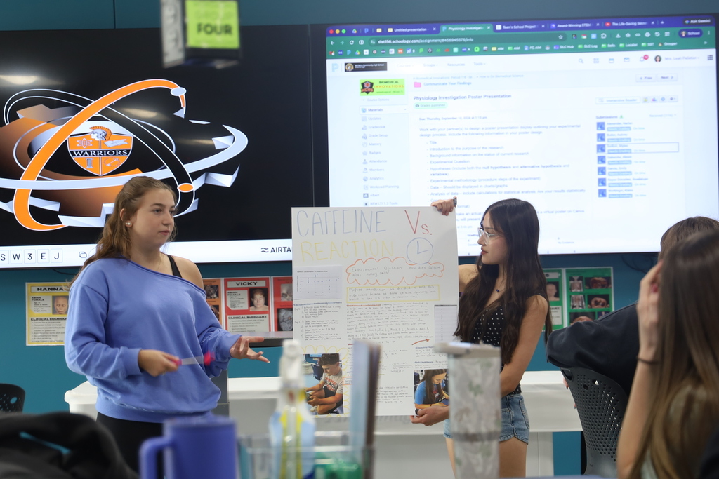 Students holding up poster thst says Caffeine vs. Reaction