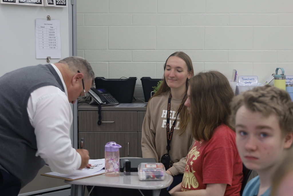 Mr. V singing student's contract