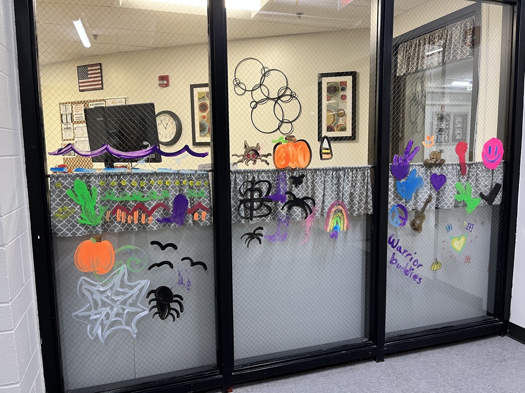 Deans office painted windows with warrior buddies drawings