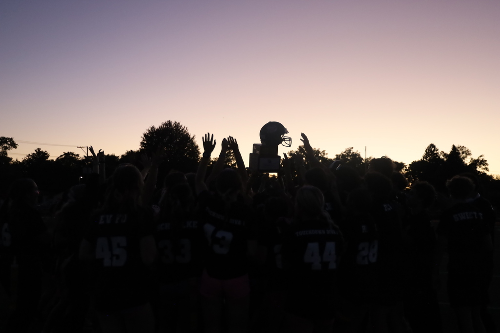 Silhouette of trophy in sunset with hands