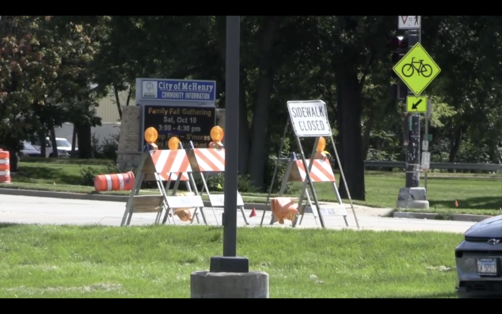 Construction signs that say Sidewalk Closed by City of McHenry sign