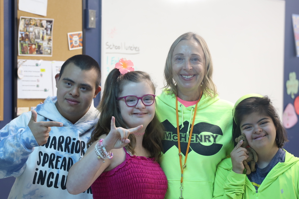 Three students and teacher in neon