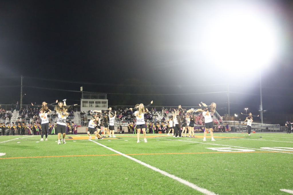 Dance partners holding up other partners on field