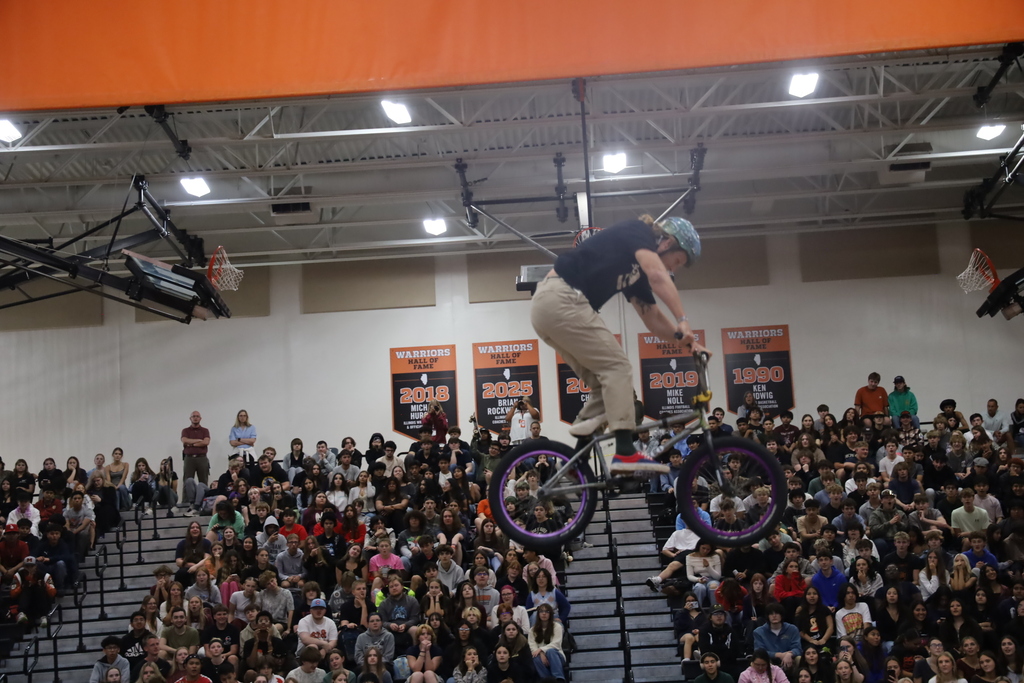 Biker in air in the gym doing stunt