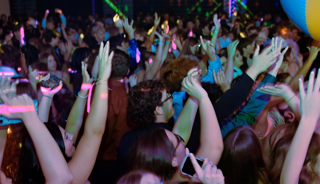 Students throwing hands up for a beach ball