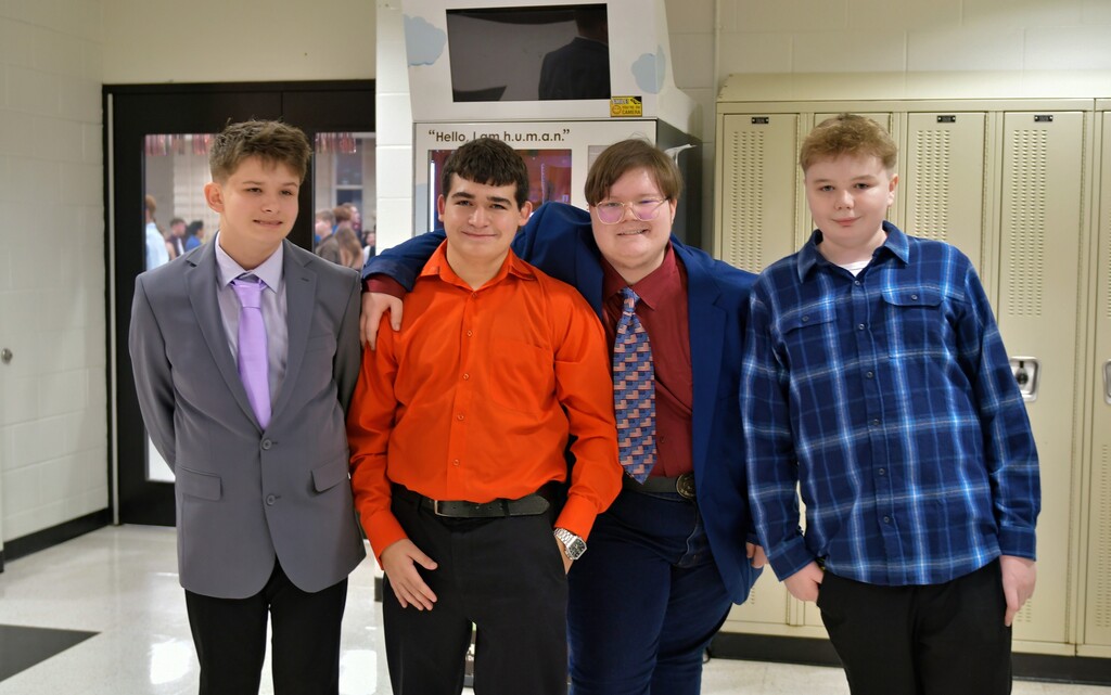 Four students posing in the hallway