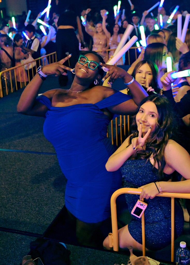 Three students posing by dance floor