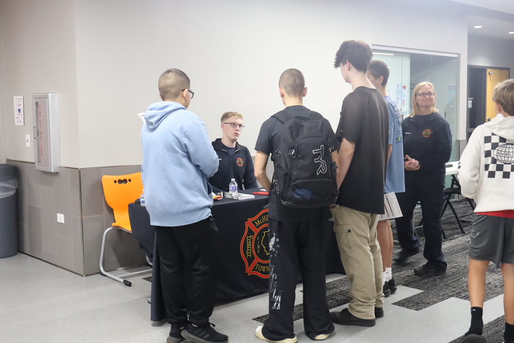 Students talking to firemen booth