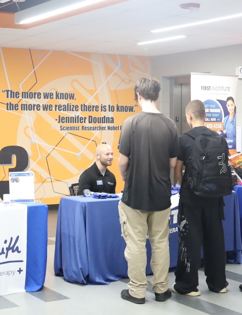 Students talking to physical therapy booth