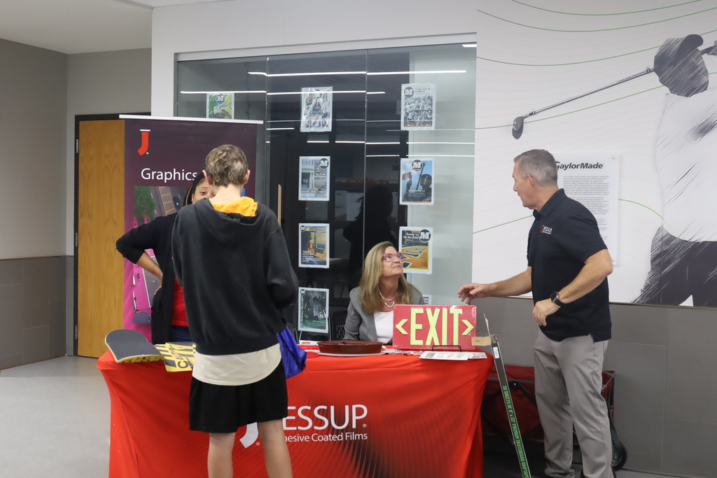 Student talking to graphics Jessup booth 
