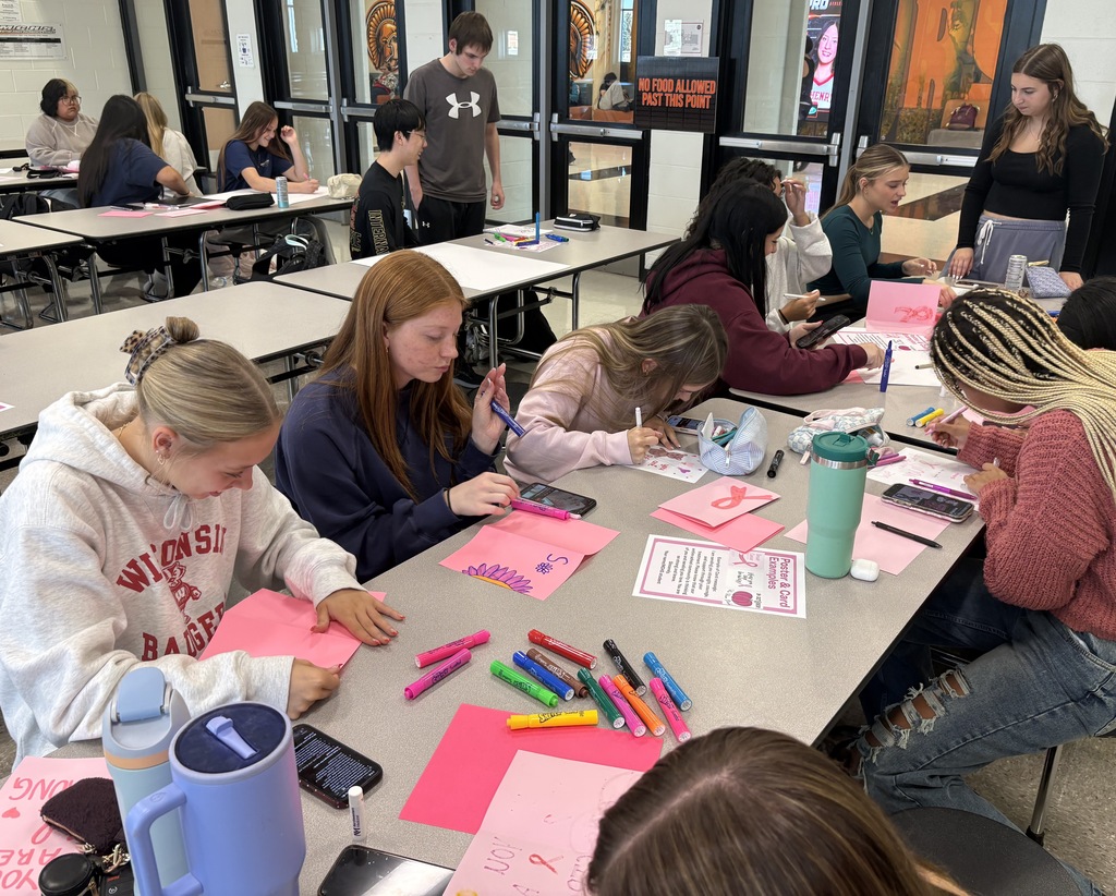 Students at a table making cards 