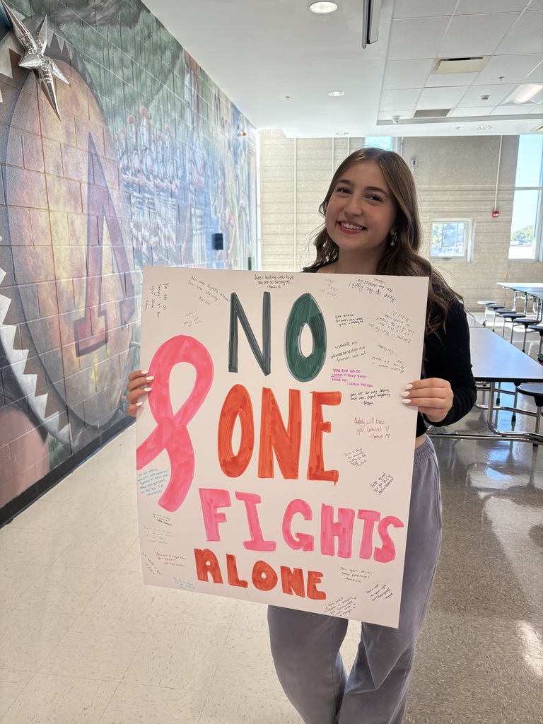 Student holding sign that says No one FIghts alone