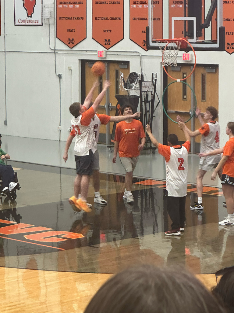 Student shooting basketball