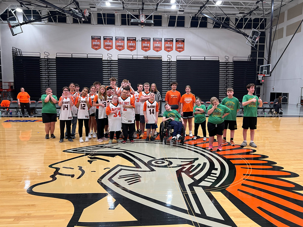 group of MCHS students and Crystal Lake studnets posing in the gym