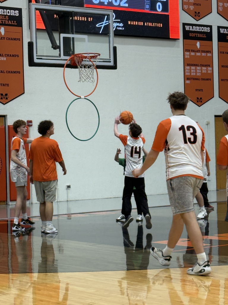Student shooting basketball