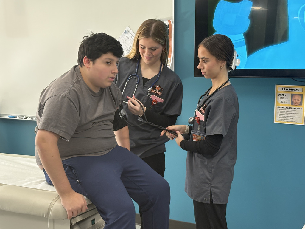 students taking blood pressure of another student