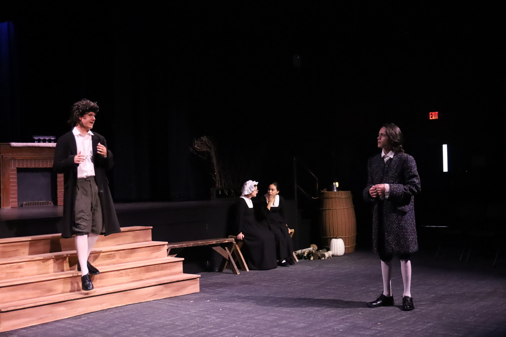 Two students talking to each other during the performance